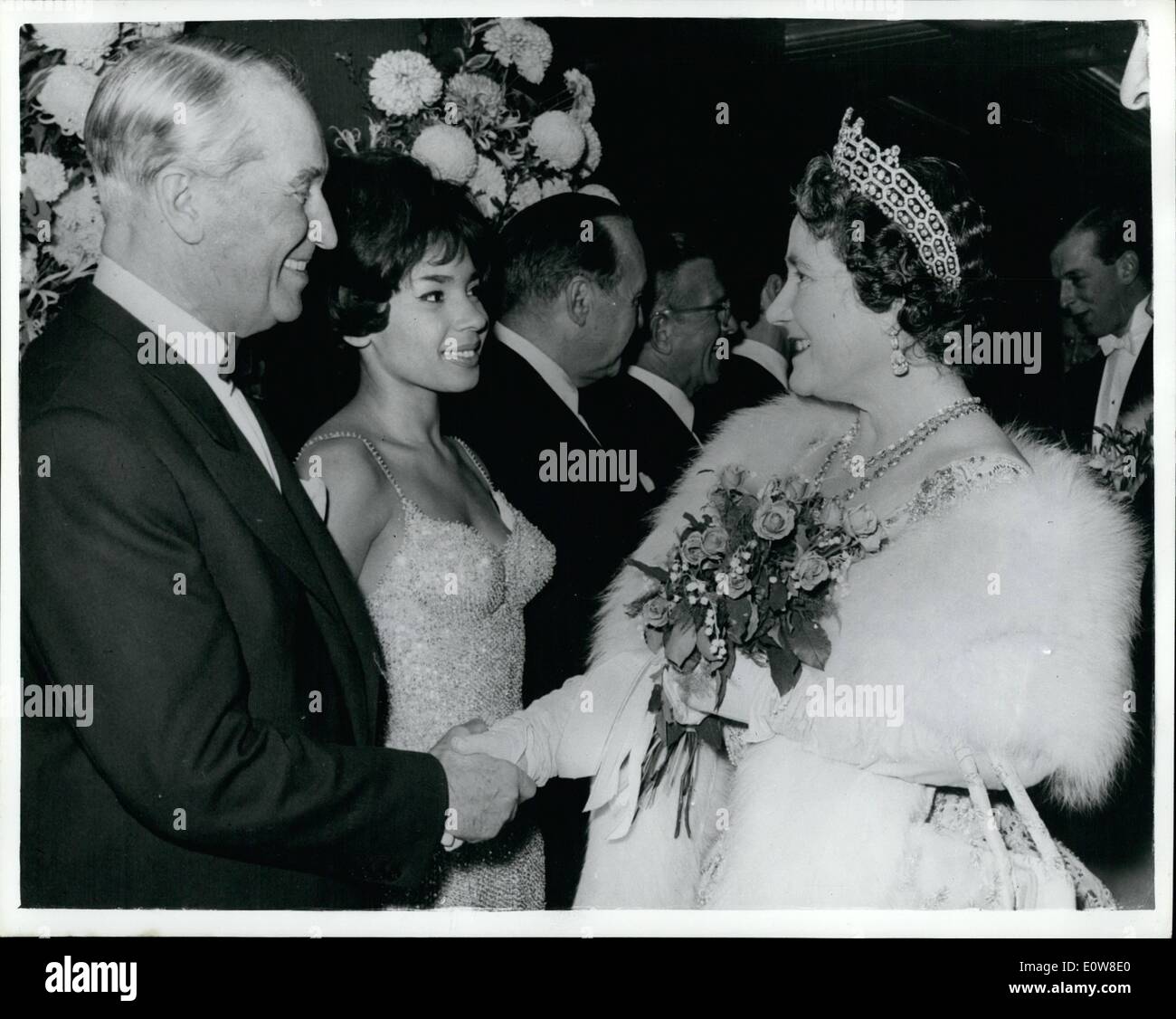 Nov. 11, 1961 - Royal variety performance held in London last night. Following the Royal Variety Performance held at the Prince of Wales Theatre, London, last night, members of the Royal Family met a number of the stars backstage. Photo Shows: H.R.H. the Queen Mother shaking hands with veteran French star Maurice Chevalier after the show, singer Shirley Bassey is also seen in the photo. Stock Photo