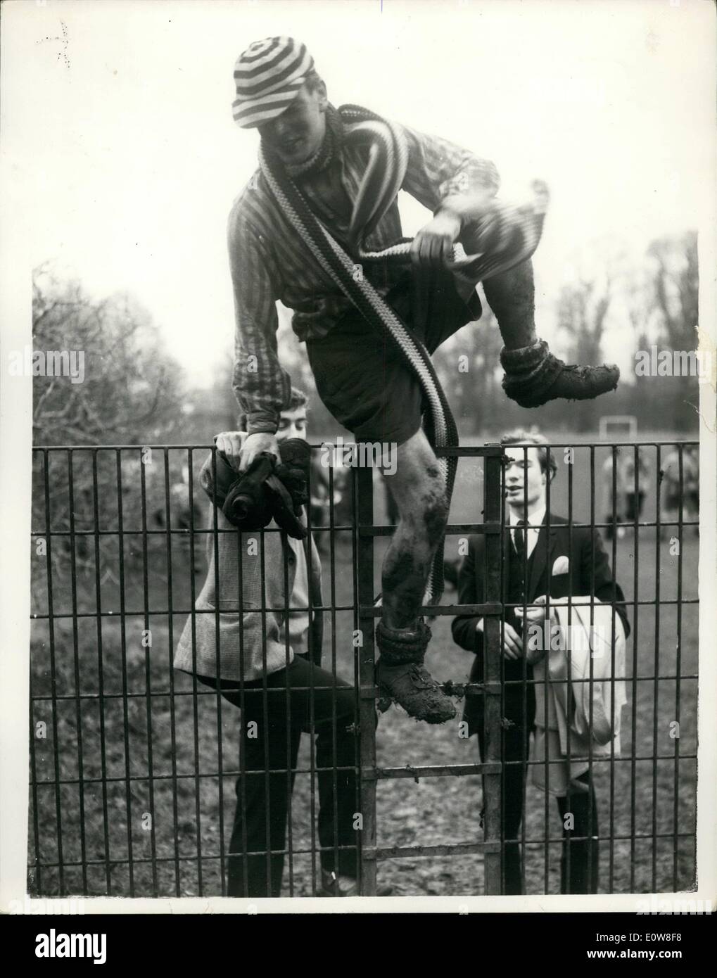 Nov. 11, 1961 - Annual St. Andrew's Day wall game - at Eton: The 110th. Annual Eton Wall Game was held this afternoon - when the Collegians obtained the first definite result in six years - by beating the Oppidanse by 2 points to Nil... Photo shows Daniel Hodson, on of the Collegians, climbs over a fence after the completion of the game today. Stock Photo