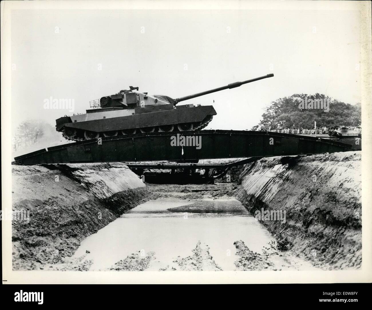 Nov. 11, 1961 - Tank Lays Bridge For New Tank: Two pictures from the British Army's Fighting Vehicles Research and Development Establishment, Chobham, England, show Britain's latest tank and a bridge laying tank. Pictured here is the 45-long-ton Chieftain, Britain's most up-to-date tank, recently taken from the secrete list, crossing a bridge laid for it by another tank, claimed to be the world's most powerful tank, the Chieftain fires a high-velocity cannon and runs on diesel fuel, high-octanes gas or Kerosene. Stock Photo