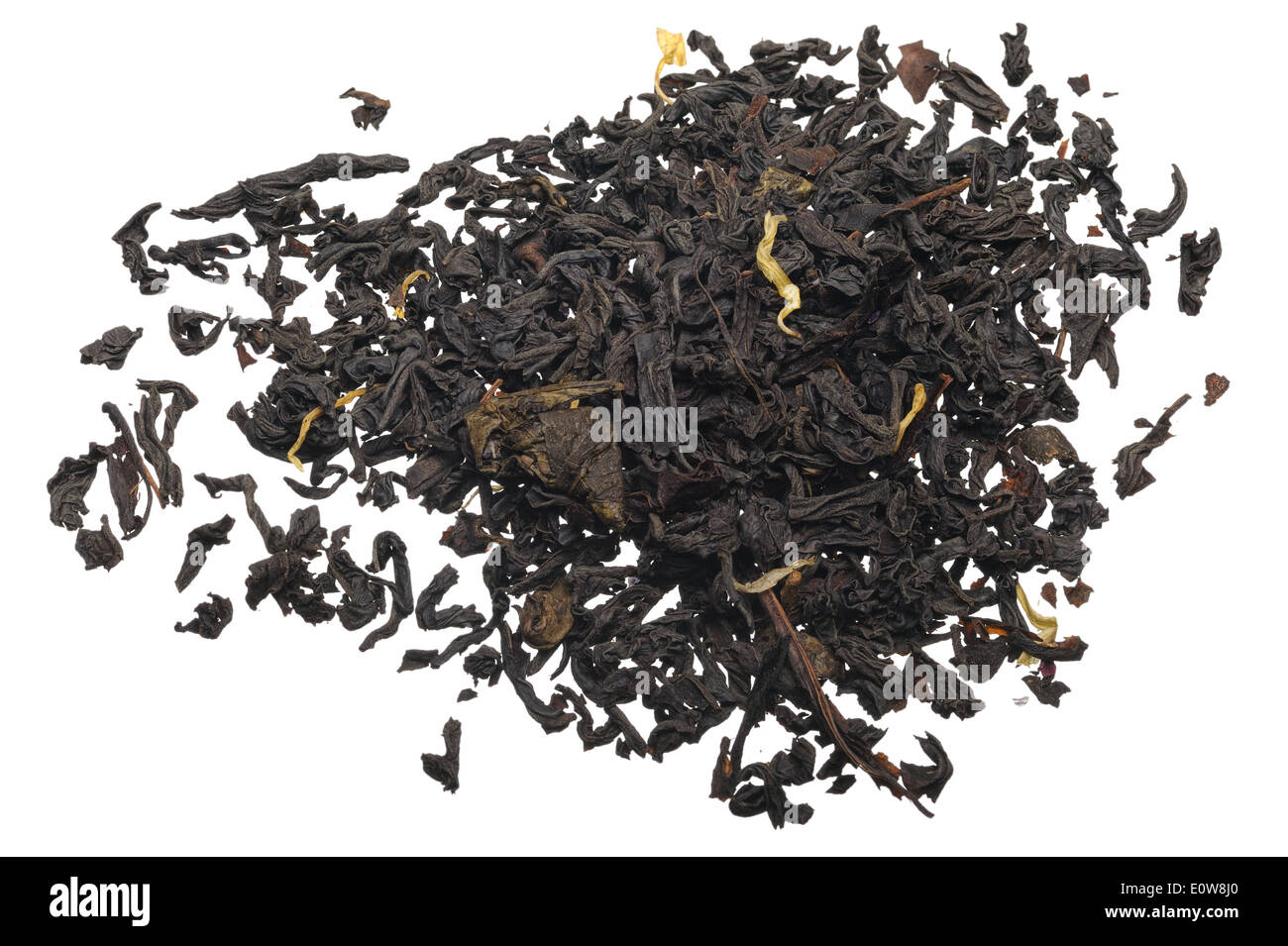Black tea with flower petals and spices on a white background. Stock Photo