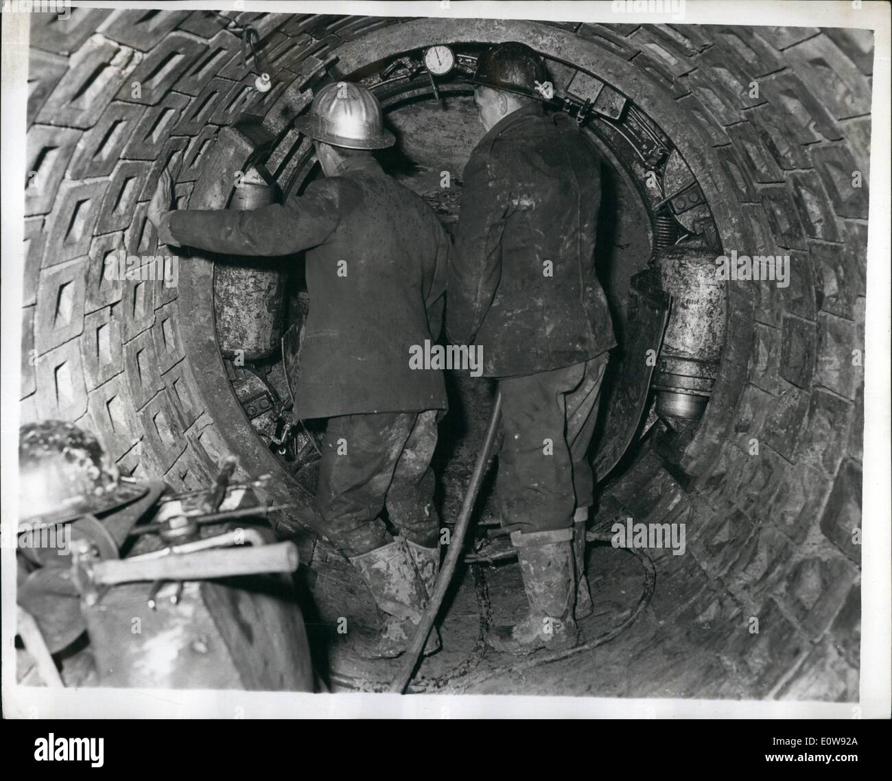 Feb. 02, 1962 - Rotating Shield Method of Tunneling Demonstrated. The new Rotating Chief method of tunneling in clay-chalk-sand-gravel etc, produced by the Butterley Company of Derbyshire, was demonstrated, at Horseley, Derbyshire, yesterday. It is being based on the use of a shield designed on the principle of an auger rotated by hydraulic jacks reacting tangentially against the end segments of the double spiral lining, which can consist of plain concrete blocks or cast iron segments. The reaction of the jacks presses the lining tightly against the clay and thus eliminating grouting Stock Photo