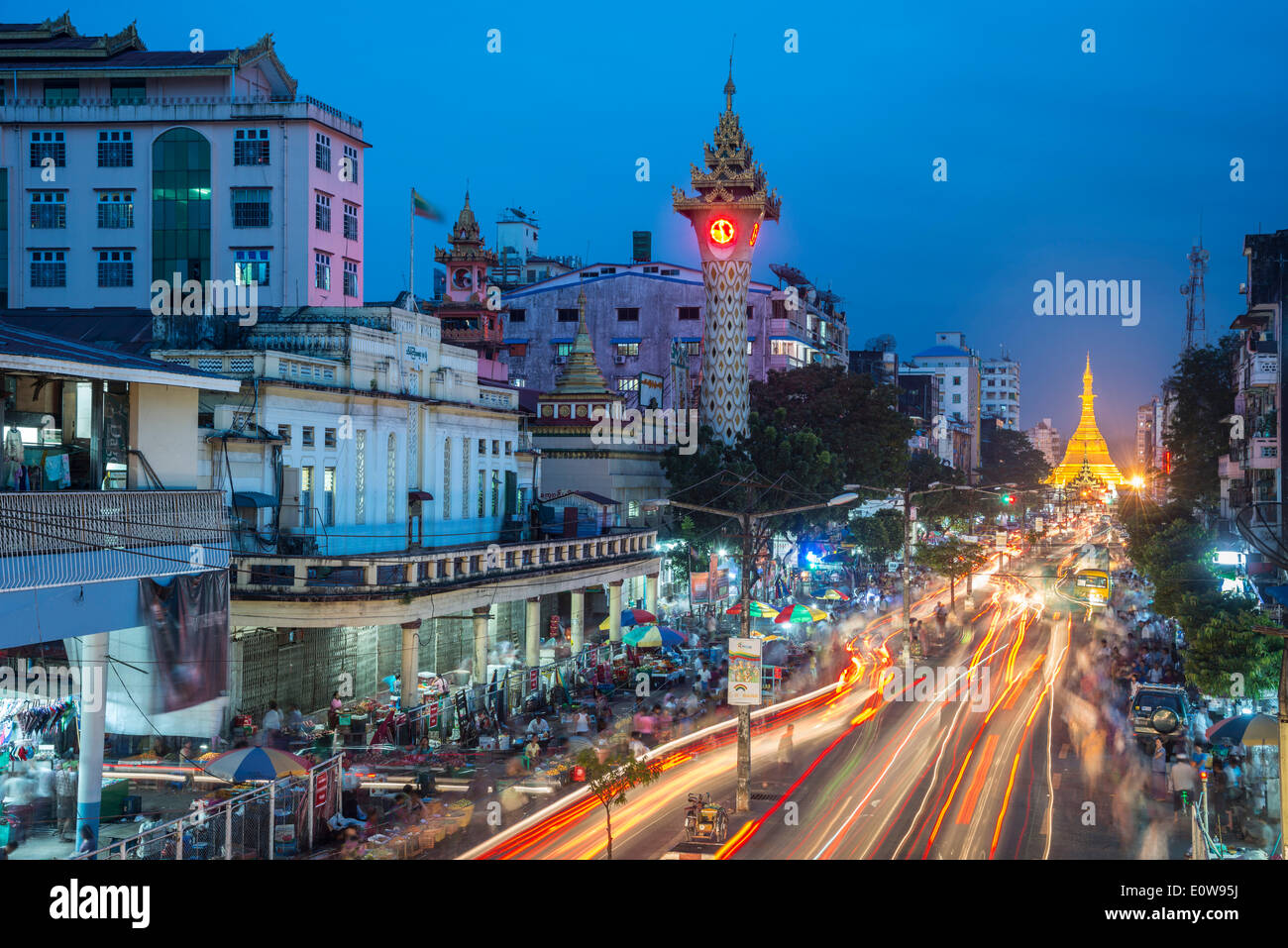 Clock tower, Sule Pagoda at the back, at dusk, blue hour, road traffic, Yangon or Rangoon, Yangon Region, Myanmar Stock Photo