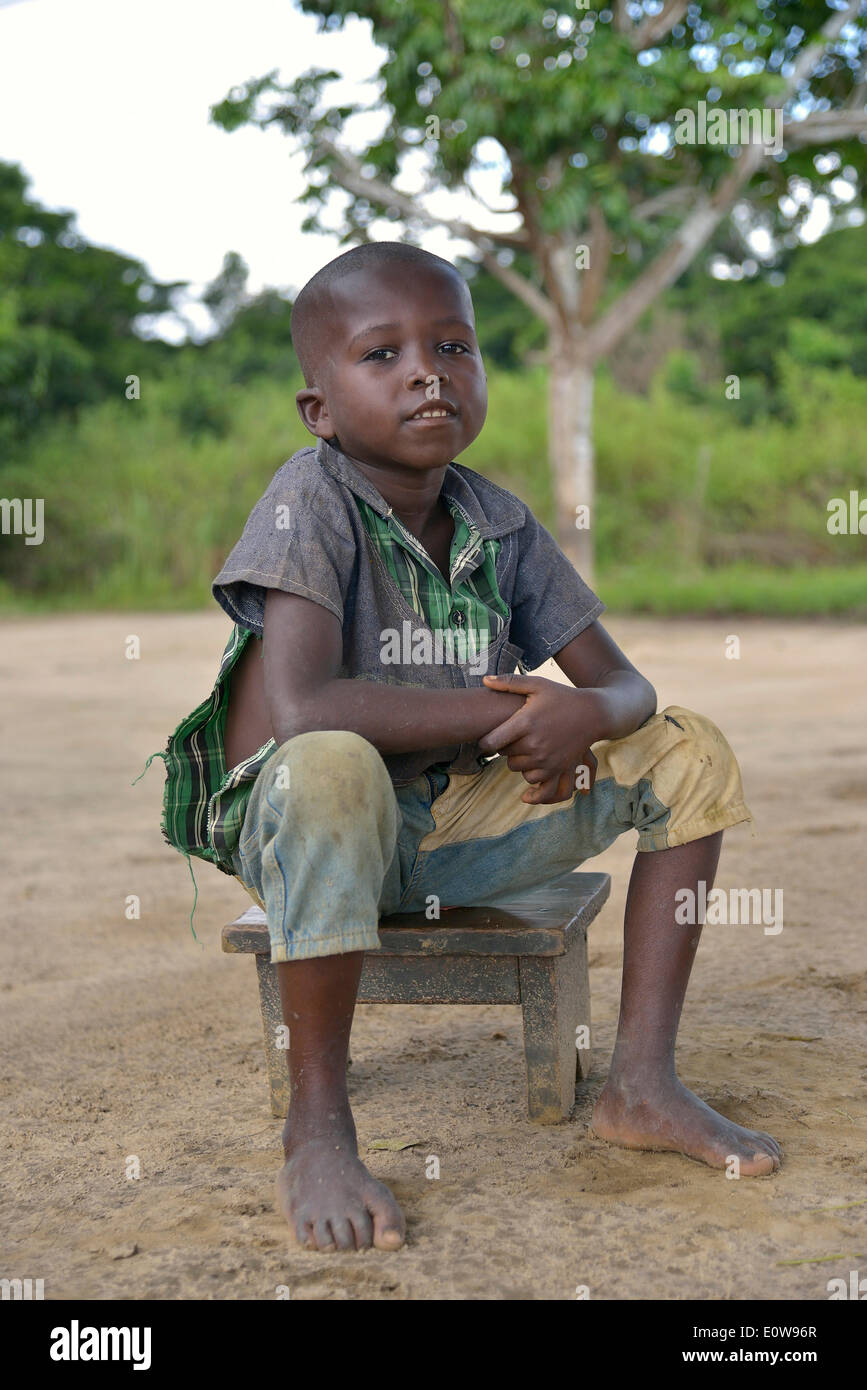 Boy sitting on a stool, Nkala, Bandundu Province, Democratic Republic of the Congo Stock Photo