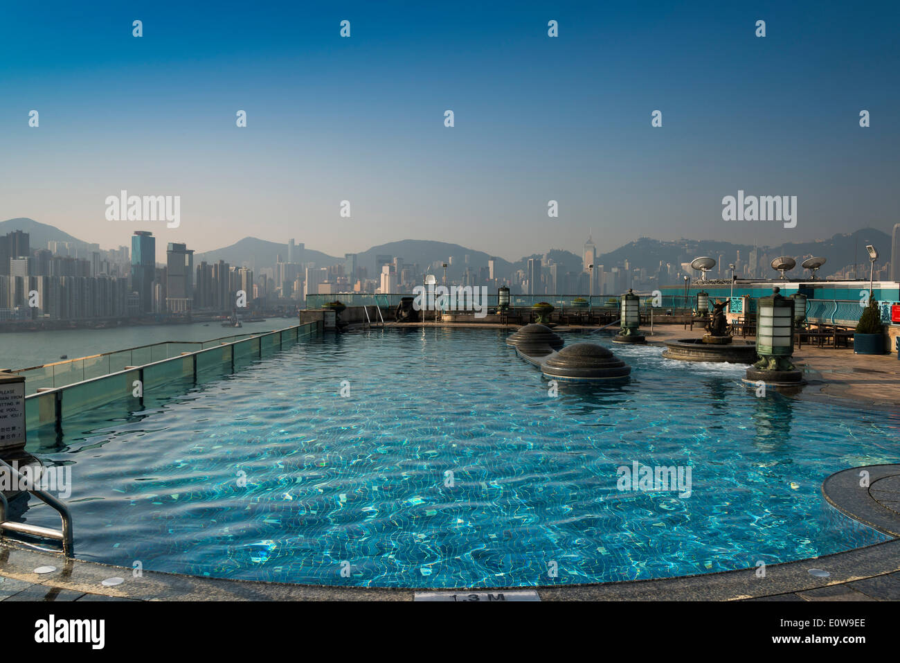 Pool on the roof of the Harbour Grand Hotel, skyline at the back, Kowloon, Hong Kong, China Stock Photo