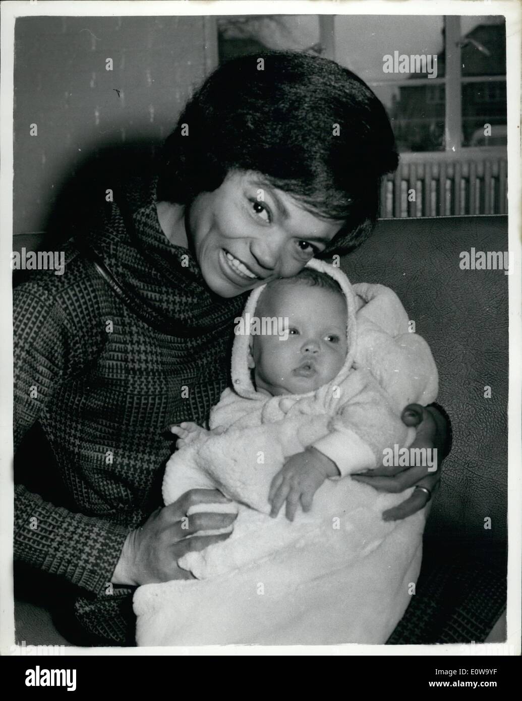 Mar. 03, 1962 - Eartha Kitt Scared By Mystery Telephone Calls Has Her Baby Flown To London From Los Angeles: A constant series of mystery telephone calls have been frightening Eartha Kitt, the sultry singer, since she arrived in London a fortnight ago. Eartha asked for her 31/2-month-old daughter, Kitt McDonald, to be flown over from Los Angeles, and was at London Airport this morning to meet her when she arrived in the company of Eartha's sister-in-law, Miss Norene McDonald Stock Photo