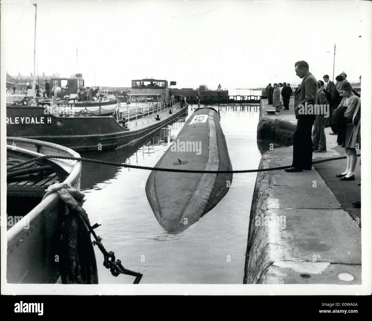 Apr. 04, 1962 - a Dracone carrying 26,000 Gallons of fuel makes experimental trip on Inland water.: Towed by a single British waterways tug, a floating Dracone, 150 feet long, sausage like container made of nylon and carrying 26,000 gallons of diesel oil, made an experimental trip from Avonmouth docks to Gloucester, passing through the look at Sharpness. yhe object of the trial is to demonstrate, among other things, that Dracones can be operated in confined waterways, Dracones 9the name comes from the ancient Greek word ''serpent'') have been used on open water and rivers aboard Stock Photo