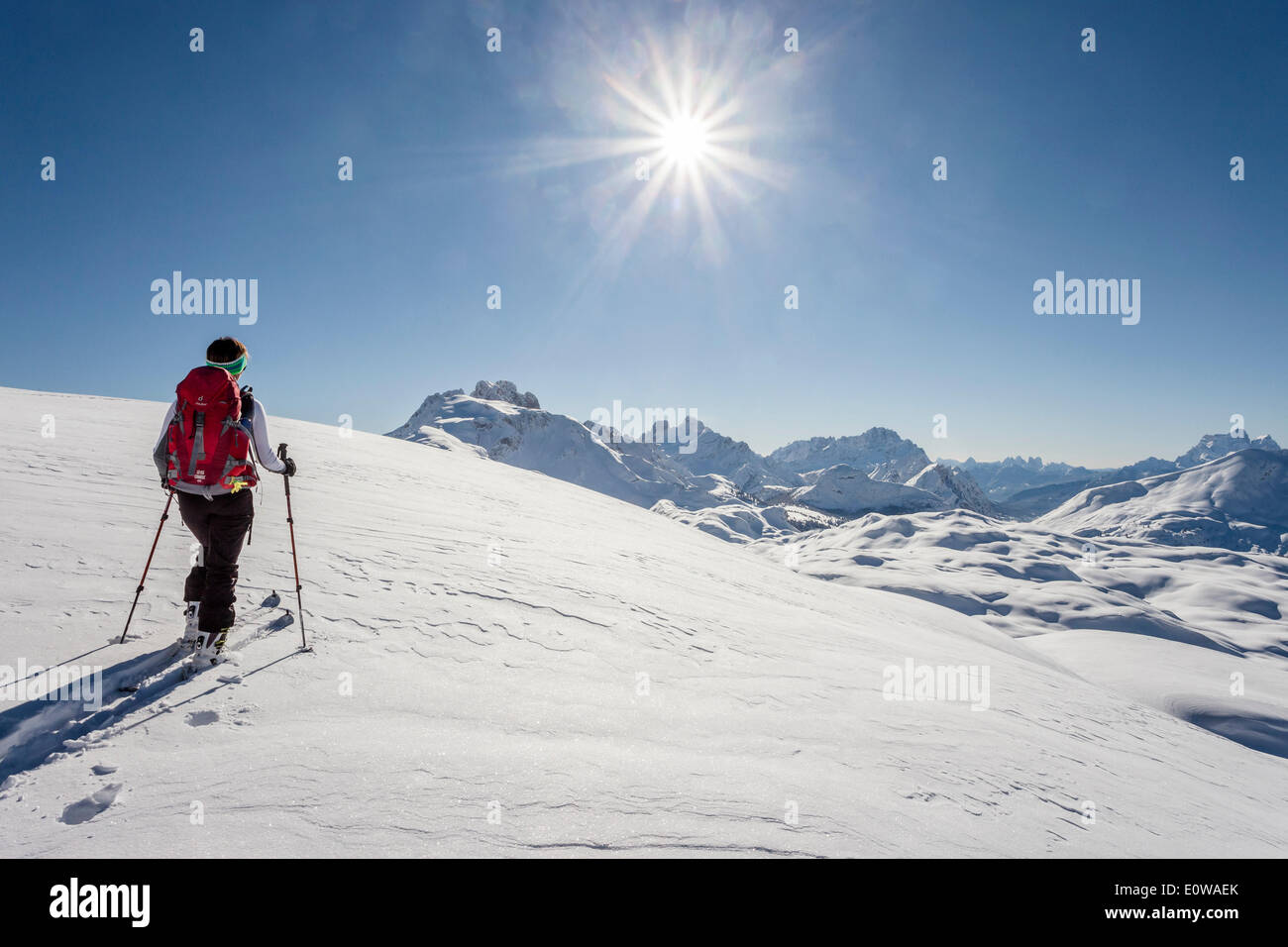 Ski tourer climbing Seekofel mountain, Fanes-Sennes-Prags Nature Park, Kleine Gaisl mountain, Hohe Gaisl mountain and Cristallo Stock Photo