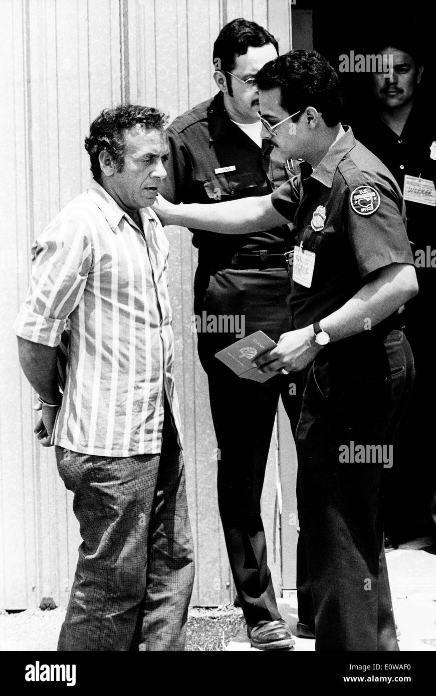Cuban Refugee talks to officials while handcuffed Stock Photo