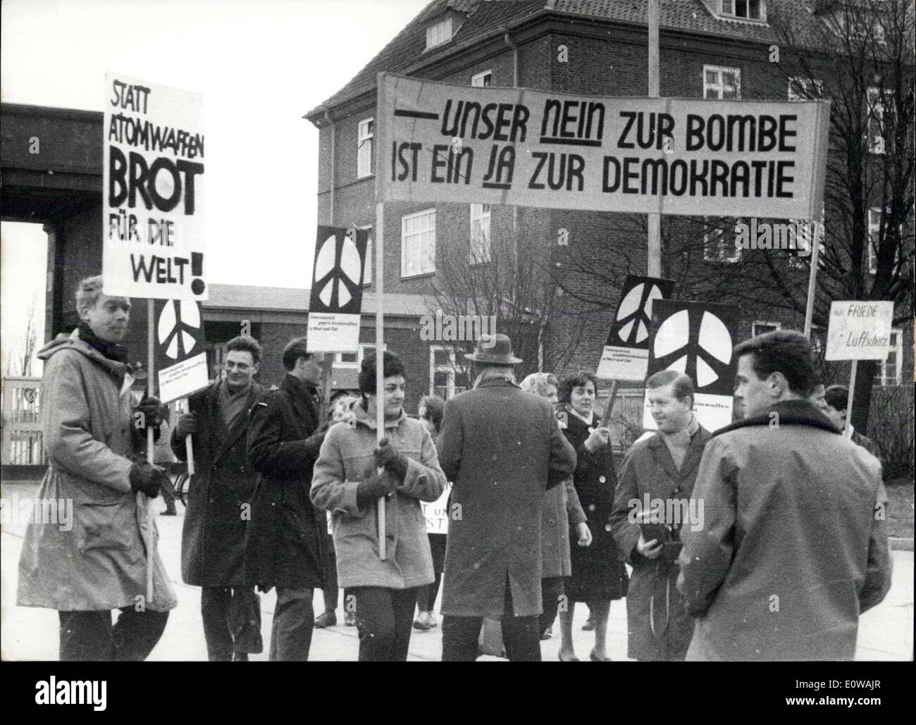 Mar. 24, 1962 - Protest against atomic energy researches ''in a quiet way'': Following the examples in England and Denmark, groups of young people protested on Saturday, March 24th, against atomic extermination of mankind in the case of a futur war. The police cared for a quiet course of the protest action. Photo shows under the symbol of the atomic opponents, a white runic letter on black field, young people marched in Hamburg Rahlstedt to the barracks there to demonstrate with transparencies and boards against an atomic armament in East and West. Stock Photo