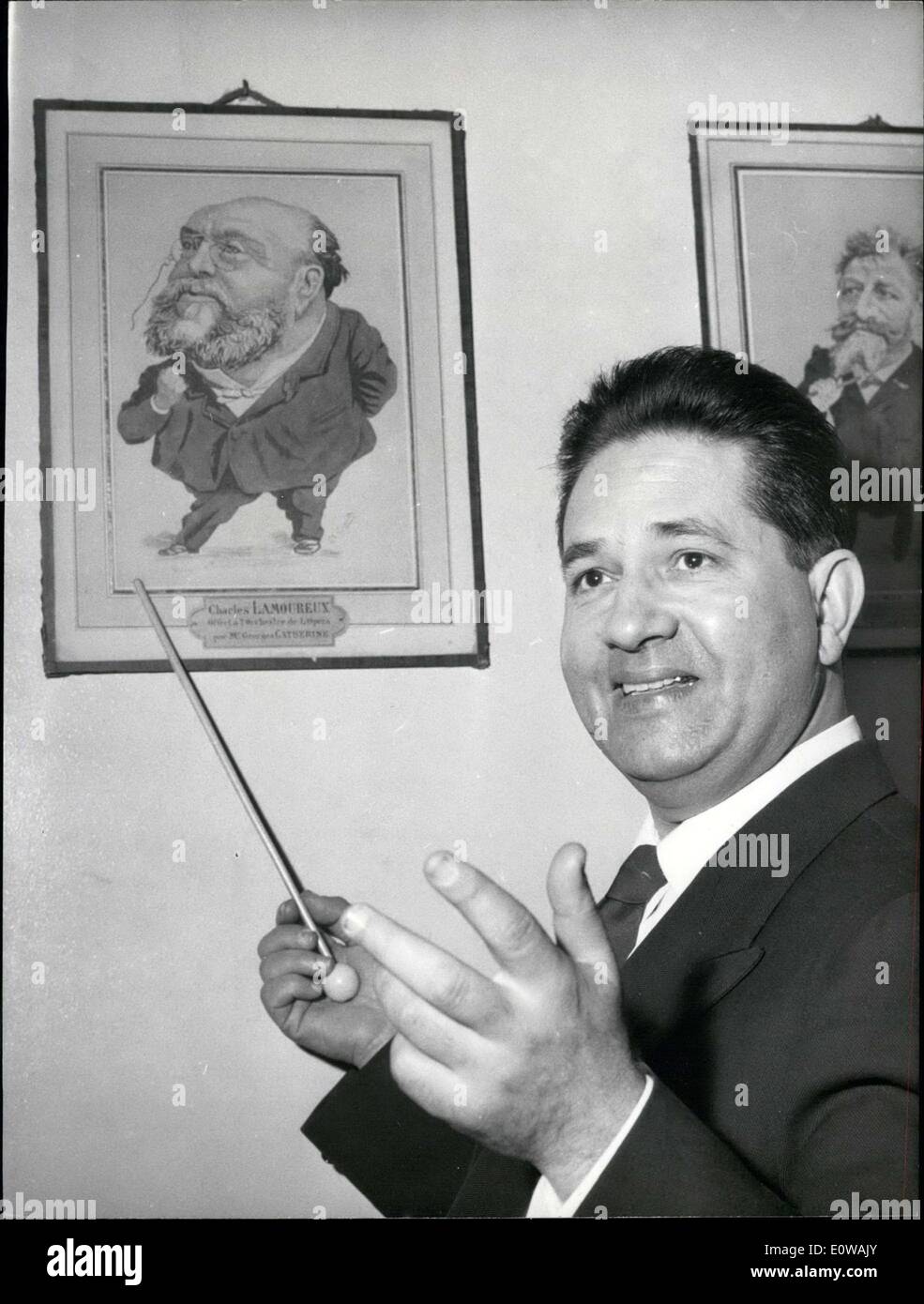 Mar. 26, 1962 - The new conductor of the Lamoureux Orchestra, Jean Baptiste Mari is pictured in front of a caricature of Charles Lamoureux, the orchestra's founder. Mari is from Algeria and was born in Palermo. At 50 years old, he is the son of a baker. He used to play the tuba solo in the Orchestra and replaced Charles Munch as conductor in America. Stock Photo