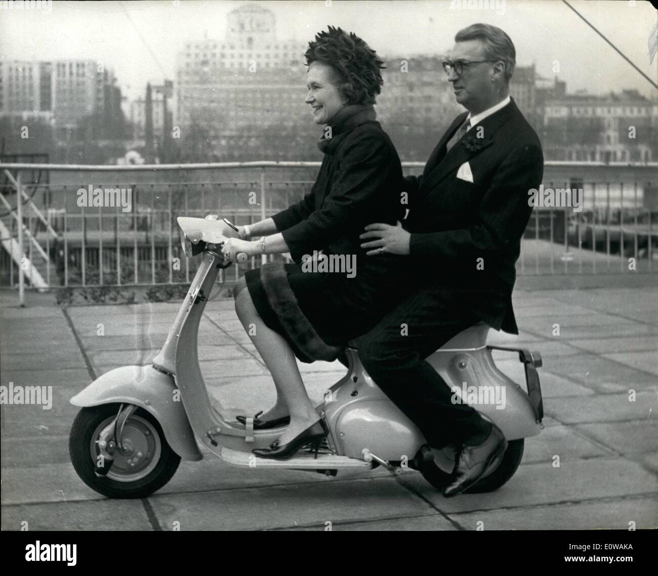 Mar. 28, 1962 - 28-3-62 Lord and Lady Mancroft go for a spin on Tina , world's cheapest, fully automatic scooter. With Lady Mancroft at the controls, Lord Mancroft went for a spin on the world's first fully automatic scooter, to sell at under &pound;100 during a demonstration at Festival Hall yesterday of the new Triumph Tina . It is claimed to be the world's cheapest fully automatic scooter. Basic price is &pound;93. 9s. It is in light blue, has a 100 c.c. engine giving 4 &frac12; h.p. at 5,000 r.p.m. The transmission is automatic with no clutch or gear lever, does 100 m.p.g. at 40 m.p.h Stock Photo
