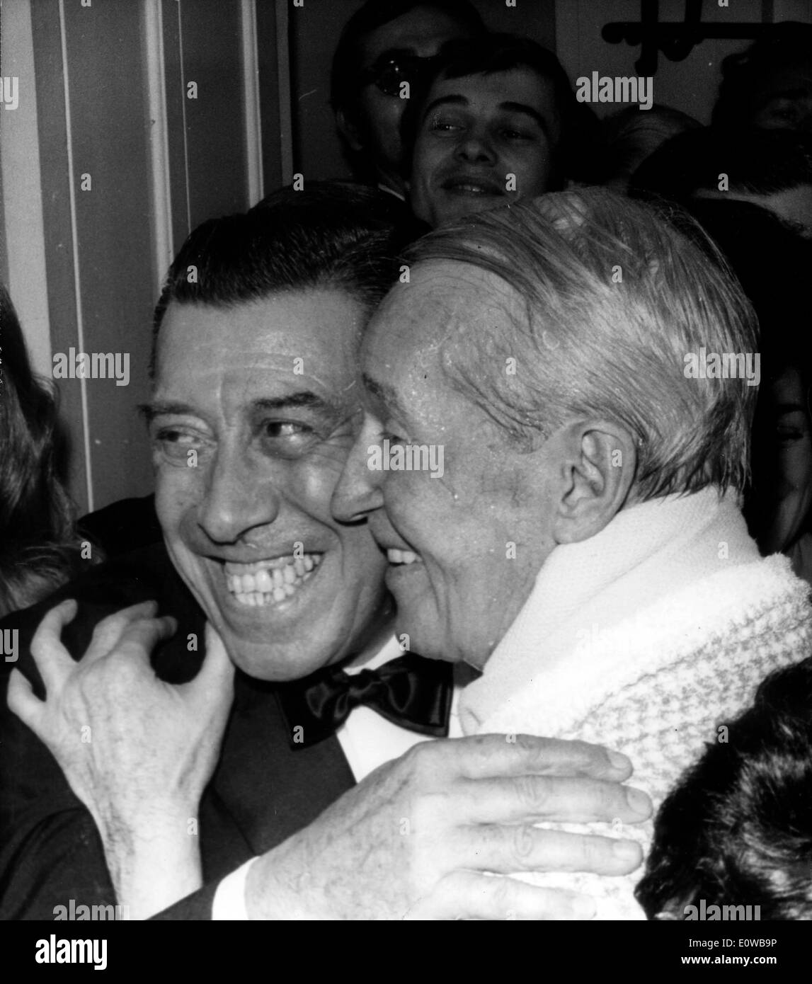 Actors Maurice Chevalier and Fernandel hugging Stock Photo
