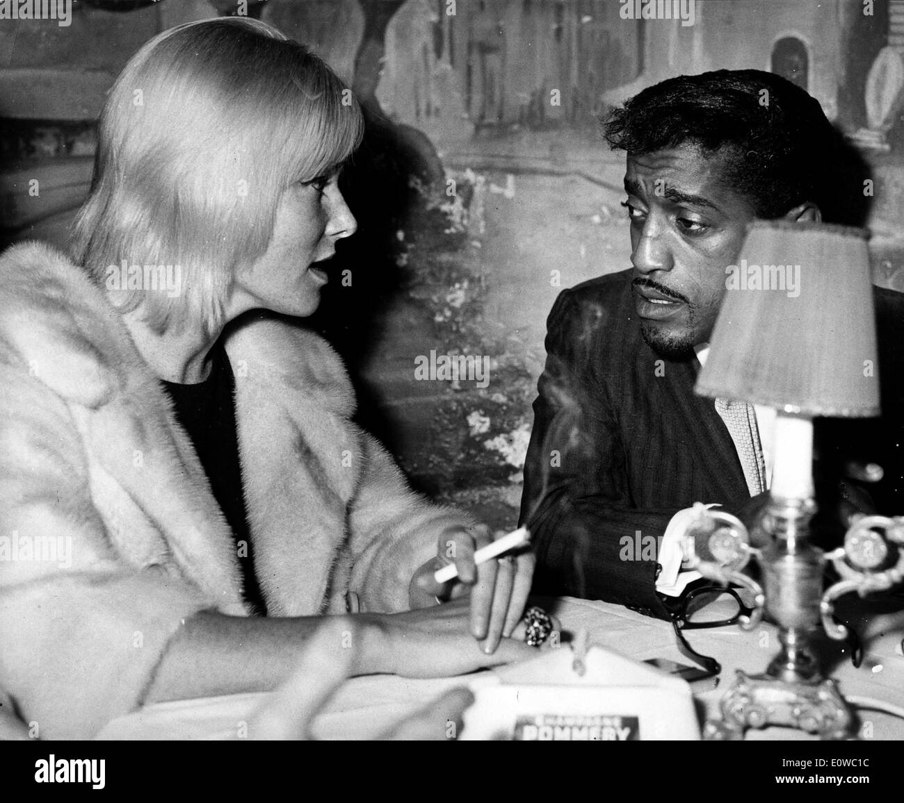Sammy Davis Jr. talking with his wife May Britt Stock Photo
