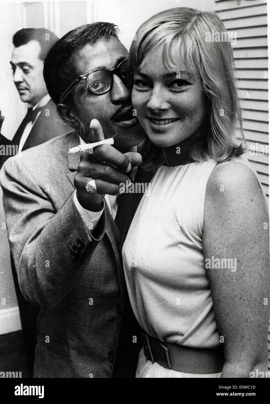 Sammy Davis Jr. whispering to his wife May Britt Stock Photo