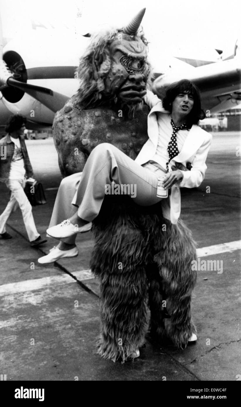 Musician Alice Cooper greeted upon arrival by a furry monster Stock Photo