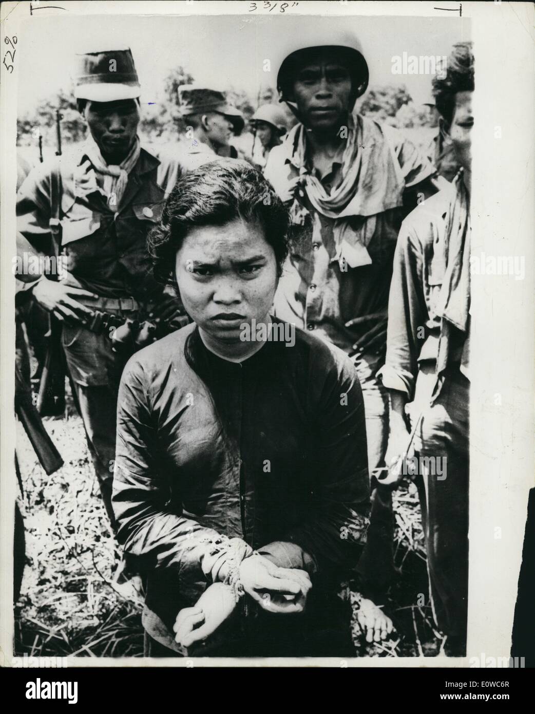 May 05, 1962 - Woman ''Soldier'' Captured In Battle With Viet Congs: Photo shows Captured by Government troops this woman ''soldier'', with her hands bound with straw, is brought in after bitter fighting with the Viet Ciong guerrillas in the Phong Dinh province of the Kekong River delta. She is probably a travelling cook who prepares foo for the roving guerrillas, 87 of whom were killed in the fighting. Stock Photo