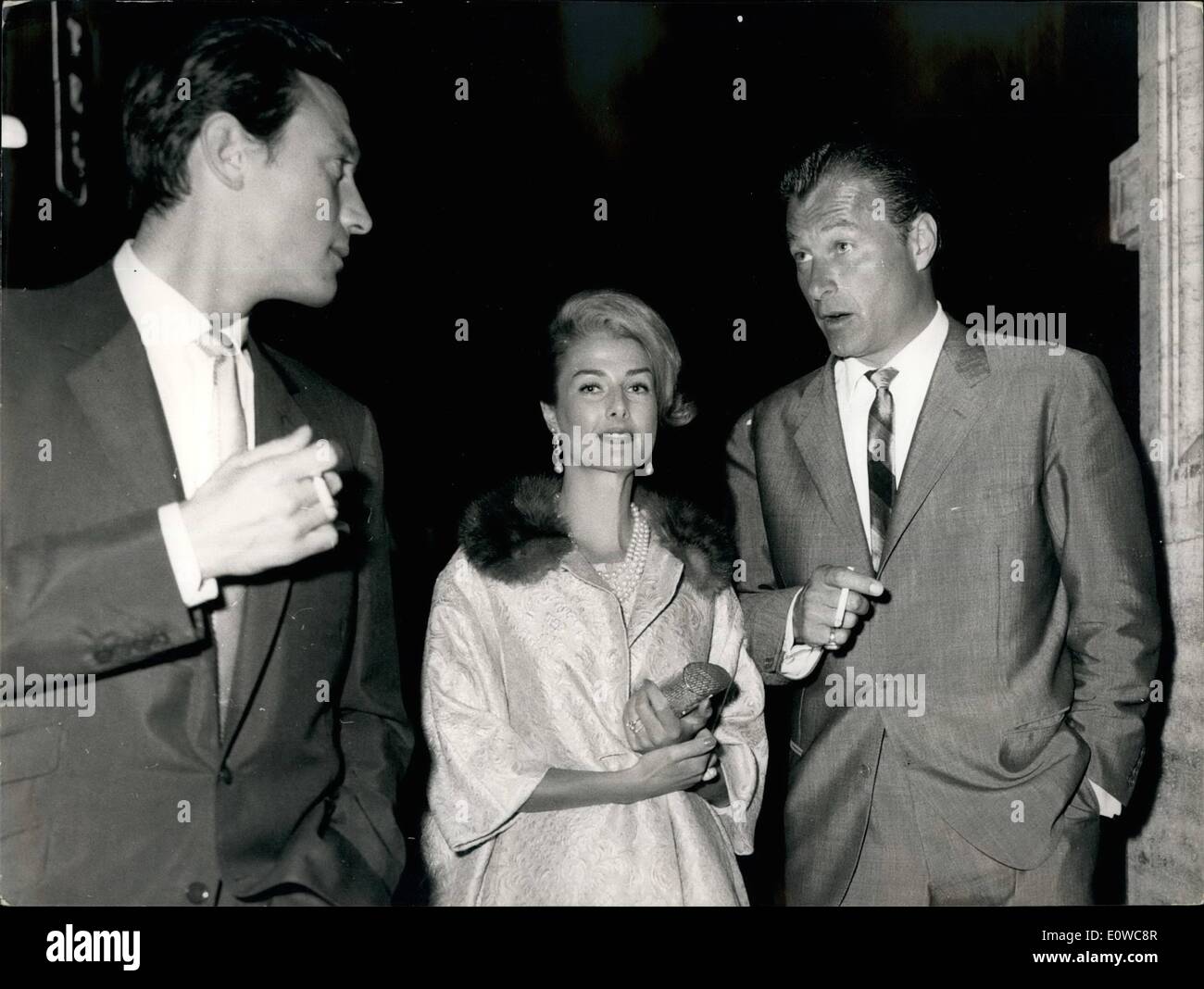 May 05, 1962 - Laurence Harvey the English actor become famous for his role in the american production ''Venere with vison'' where he was partner of Liz-Taylor. seen in via-Veneto together with also well-known Tarzan Lek Baker and his wife. Stock Photo
