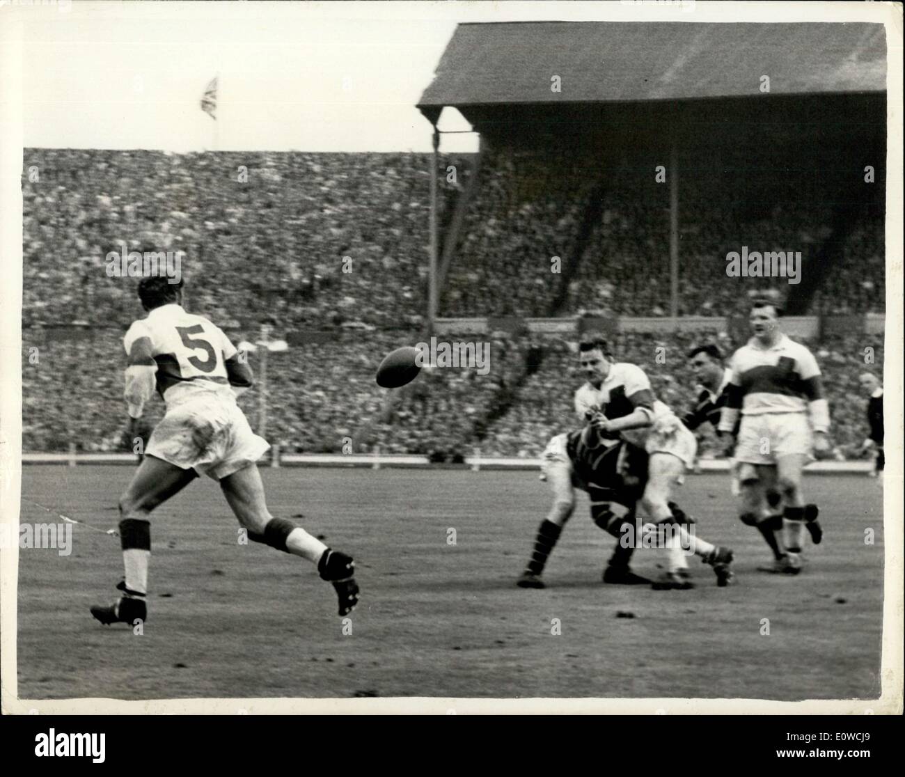 May 12, 1962 - Wakefield Trinity Beats Huddersfield 12-6 to win rugby league challenge cup at Wembley. Photo shows B.Briggs, Wakefield's second row forward, passes to teammate K.HIRST (No.5, the left wing three quarter), as he is tackled by a Huddersfield player. Stock Photo