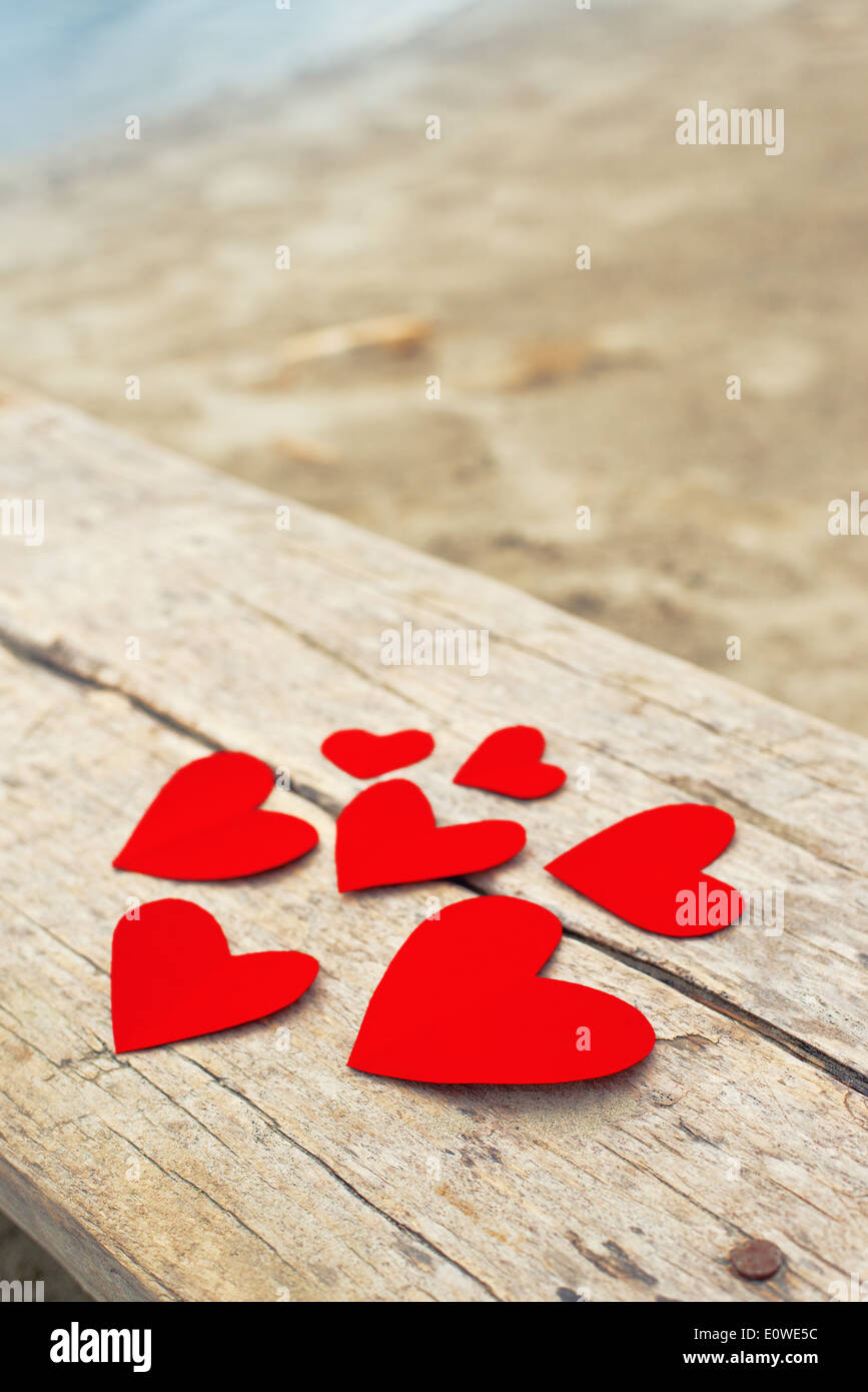 Red paper hearts on grunge wooden background with copy space for your ...