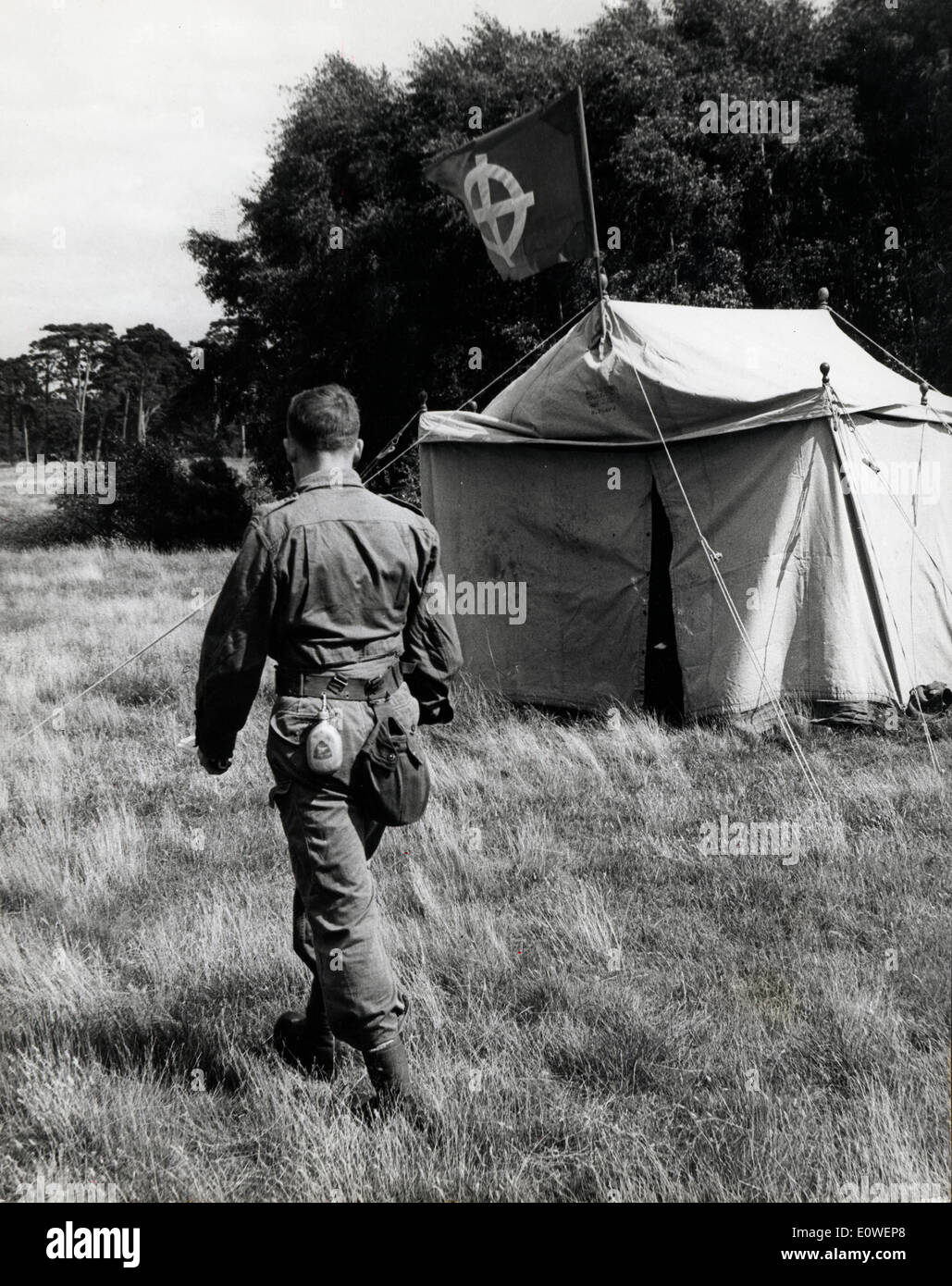Neo nazi in paratrooper uniform walks past tent Stock Photo
