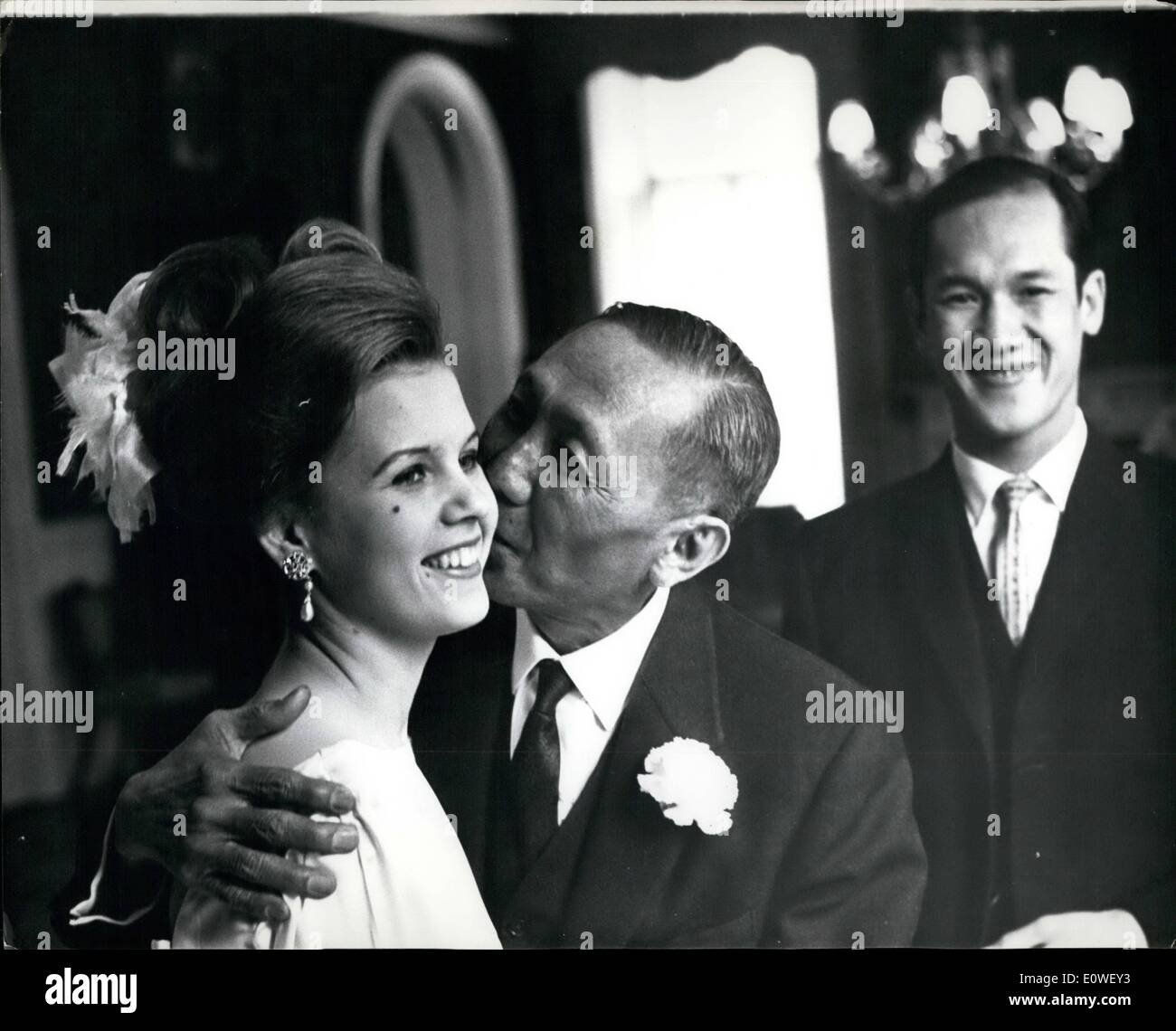 Oct. 10, 1962 - German Girl Weds Thai Diplomat Son: Karin Stahn, A 21-year-old German girl, was married in the Thai Embassy in London yesterday to 26-year-old Piya Malakul, second son of the Thai Ambassador, Mom Luang Peekdhip Malakul. Karin, who comes from Frank Frost West Germany, works in the foreign section of the West ,minster Bank in Threadneedle Street, London. Phot Shows The Thai ambassador has a kiss for the bride. Bridegroom Piya is ion the right. Stock Photo