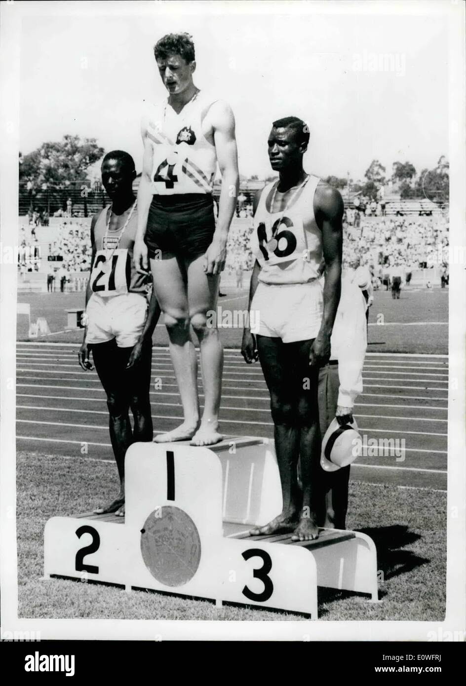 Nov. 11, 1962 - AUSTRALIAN ON WINNER'S DAIS. PHOTO SHOWS: K. ROCHE of AUSTRALIA on the victory hurdles in the British Empire and Commonwealth Games at Perth. On his left is second place K. SONGOK of KENYA and on his right is ISHIEPAI of UGANDA who ran third. Stock Photo