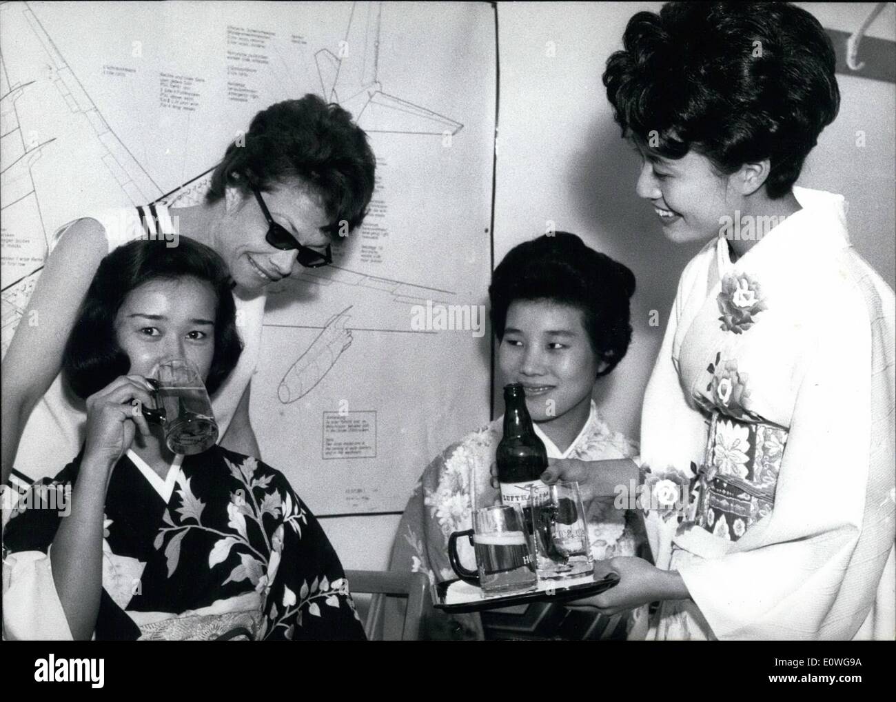 Sep. 09, 1962 - Charming Japanese Girls....are getting the finishing touch in serving from chief Lufthansa Stewardess Ursula Tautz (Tautz) in Frankfurt, for soon they will be on duty as Stewardesses on the Far-East-line. So Zinaida, Hisako and Yasuka have to learn how to pour the beer in the glass that it gets the right forth, for ever thursty passenger in a height of 500 m is fond of a nice cool beer. Stock Photo