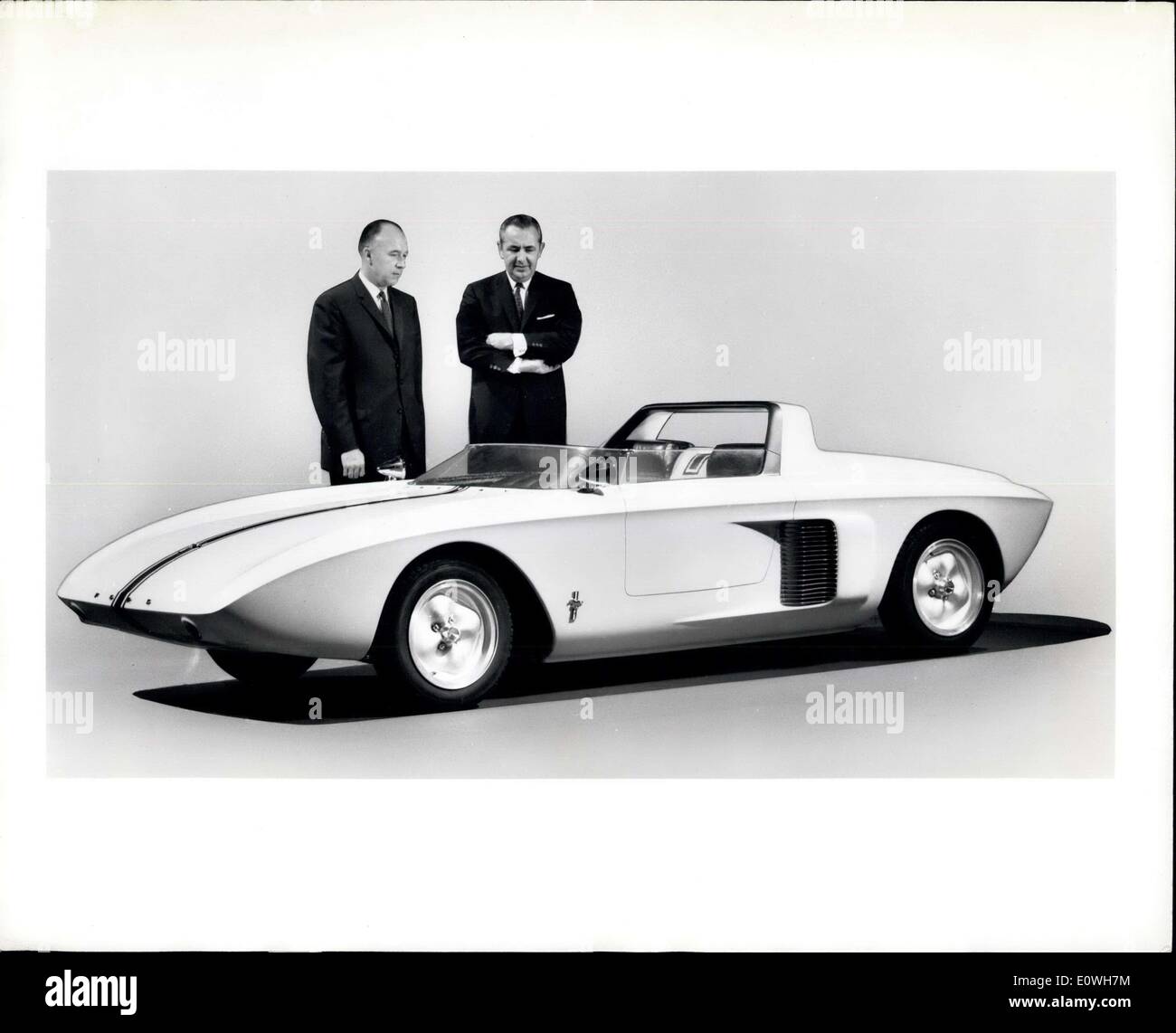 Oct. 07, 1962 - The only one of its kind -- that's the Mustang, experimental sports car introduced today by the Ford Motor Company. The two Ford executives responsible for its development are H.K. Misch, Vice President-engineering and research staff (left) and Gene Bordinat, Vice-President-Styling. The Mustang is powered by a V-4 engine, has 106 horsepower and a top speed of 117 miles an hour. Engine location is midship. the Mustang is only 28.8 inches hight at the peak of its hood. Wheelbase is 90 inches and over all length, 154 inches Stock Photo