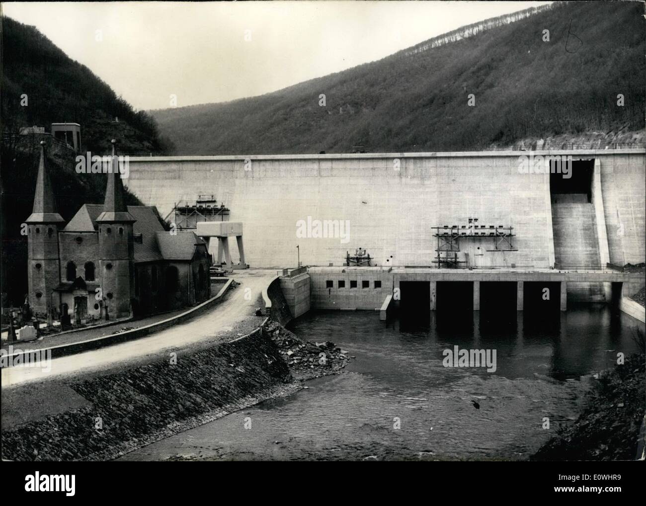May 05, 1963 - Worlds biggest pumping elevator power plant is under construction at Vianden on the Our, a small river dividing Germany and Luxembourg. A giant dam holds the water in a big resevoir. At night it is pomped up 800 feet high to a great reservoir holding 7 million cubicmeters of water. The power plant, which will be completely ready in 1964, will produce 1,3 milliards of kilowatt-hours of electricity. In the first phase completed now, it produces 600 million kilowatthours. Photo shows the dam near Vianden, only a little smaller as the towers of the anciant church. Stock Photo
