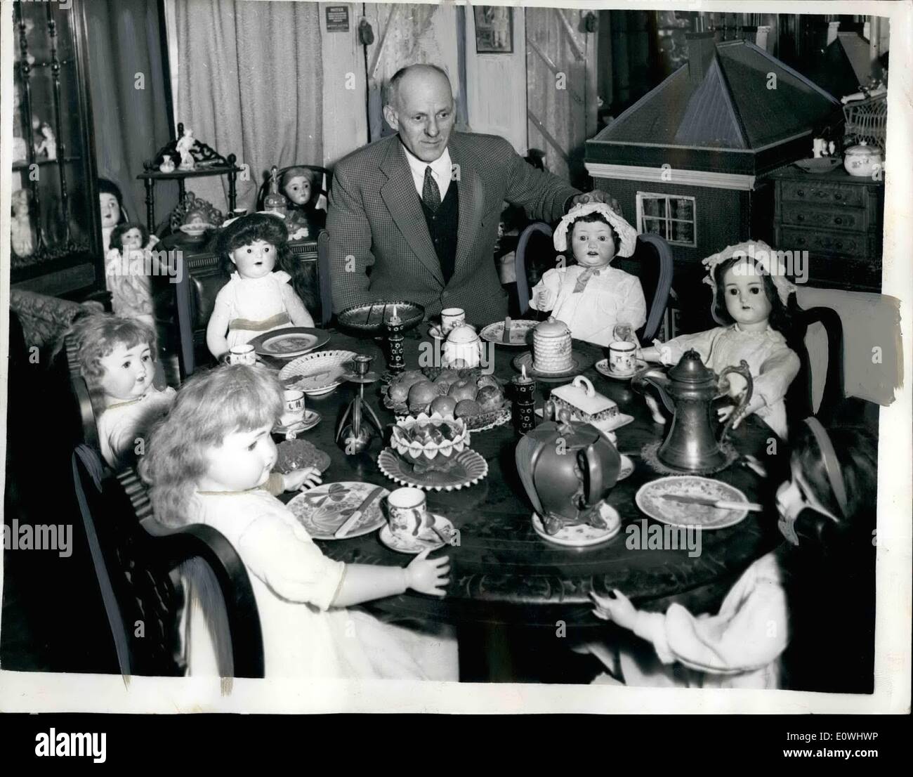 Feb. 05, 1963 - 5-2-63 Mr. Elder in his House of Dolls valued at between &pound;3,000 and &pound;4,000. Mr. Barry Elder (45) who lives in Glenthorne Road, Hammersmith has one aim in life - and that is to form a Museum of Dolls.. Mr. Elder - his wife Jean and ten year old Susan live in one room in the house - the remaining six rooms are devoted to the dolls. Mr. Elder says that the cost of maintaining his doll museum is crippling - and for a year they lived on a soup and sandwich diet.. During the day - Mr. Elder shows visitors around his Museum - and at night he works - cleaning a factory Stock Photo
