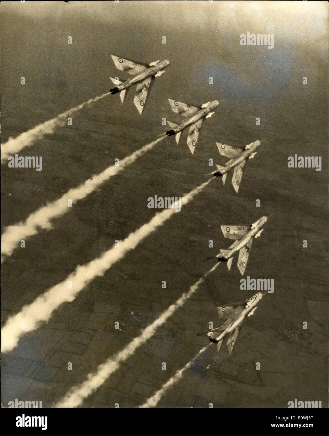 May 14, 1963 - New R.A.F. Aerobatic team shows it's paces.: ''The Firebirds'', No. 56 Squadron of Fighter Command who are the 1963 aerobatic team were practising in their English Electric Lightenings over East Anglia yesterday. Photo shows the team perform a roll high over the countryside. Stock Photo