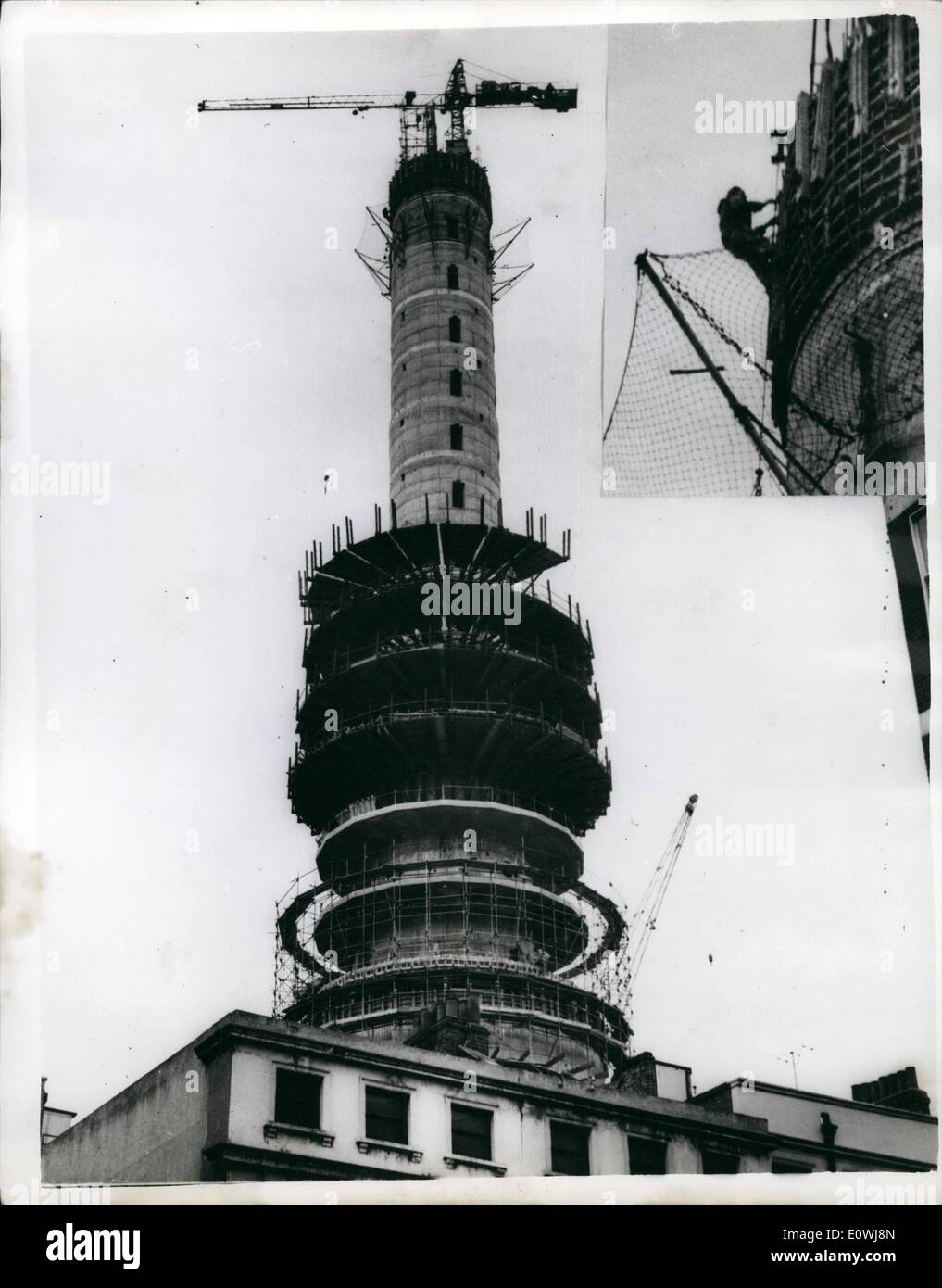 Mar. 03, 1963 - London's Highest Workman.: The man with the highest job in London was hard at work as usual today on the 62ft. Post Office radio and television tower being built off Tottenham Court Road in London, Next year visitors with a head for heights will be able to share his view in comfort from the revolving restaurant which is to be built near the top. Photo shows in the large picture a workman can be seen at work on the 620-feet high Post office radio and television tower. (inset) shows a long focus shot of the same man at the top of the tower (note the safety netting) Stock Photo