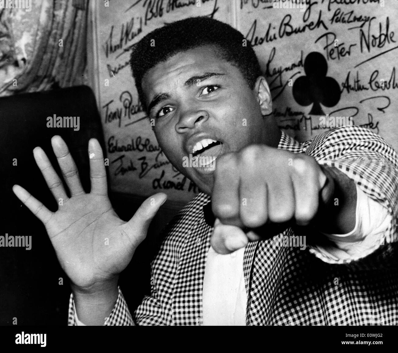 May 27, 1963; London, UK; Loud-mouthed CASSIUS MARCELLUS CLAY, the American heavyweight boxer who's voice is insured for 21, 000 pounds while he is in this country, has arrived to fight Henry Cooper. The picture shows Cassius Clay holding up five fingers to denote which he will knock out Henry Cooper in and also holdss up the first which will do the damage. Stock Photo