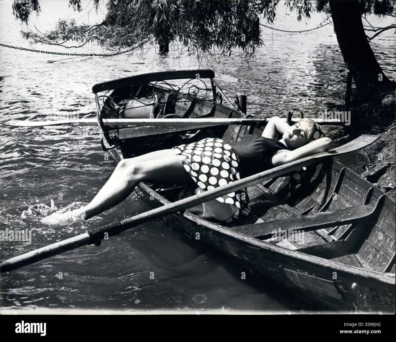 Jun. 06, 1963 - A real cool June. Flaming June starts today and who better to introduce it than a girl called June. Actress June Ritchie celebrated her 22nd birthday yesterday by relaxing on the Serpentine in London while the rest of the city sizzled in the eighties. Stock Photo