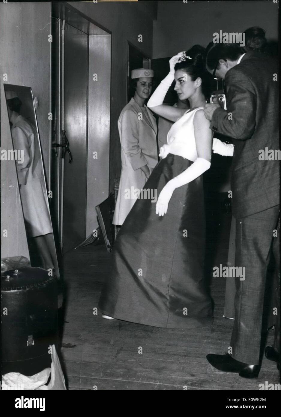 Apr. 04, 1963 - Just a glance at the mirror and then she is going on the gangway. To become a mannequin is the wife of a great lot of girls, but only a very small part of them is predestinated, because this is a very hard job. To hasten from the one dress parade to the other, to appear always smart, that needs such a lot of discipline, which do not have each girls who wants to become a mannequin. Stock Photo