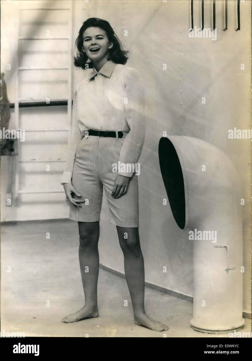 May 05, 1963 - ''Cote D' Azur'' Fashion.: This summer fashion will look like this white cotton blouse with a black leather belt. White and beige collar is matching with the Bermuda-Shorts. Stock Photo