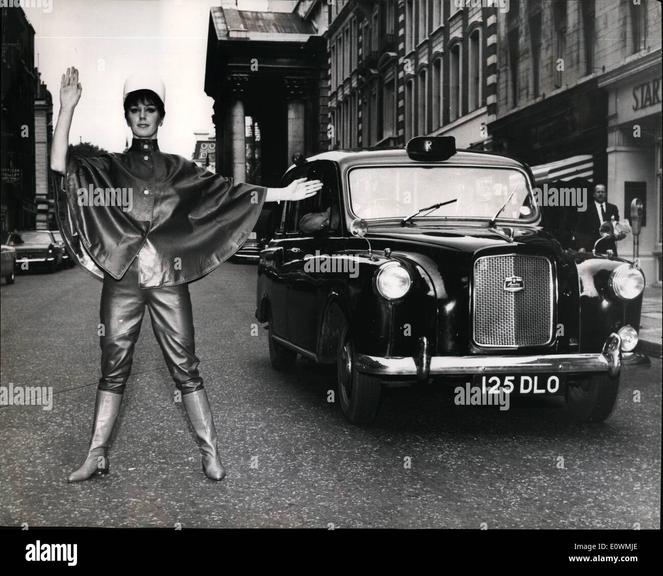 Sep. 09, 1963 - A Real ''Traffic Stopper'' - In any language: The London cab driver was just a little shaken when he found himself held up by the strong arm of the law apparently from across the channel. He soon got over his surprise enough to admire the outfit which looking something like the uniform of the Paris Gendarme is actually a creation in leather. Worn by Beverley Scott it is one of the styles from the Nina Ricci collection displayed at the Westbury Hotel London today. Stock Photo