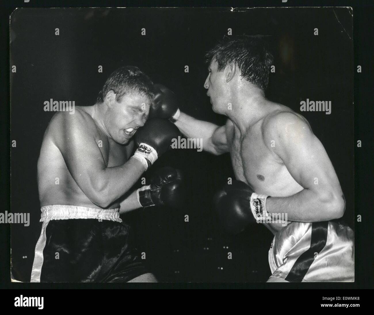Sep. 09, 1963 - BILLY WALKER TAKES ONE TO THE HEAD.. BEATS PRESCOTT IN A TECHNICAL K.O... The face of west heavyweight Billy Walker (left) is distorted as he takes a right to the head from Birmingham's Johnny Prescott during their contest at the Wembley Stadium - last night . Walker scored a technical K.O. when the referee stopped the fight only seconds before the end of the last round. Stock Photo