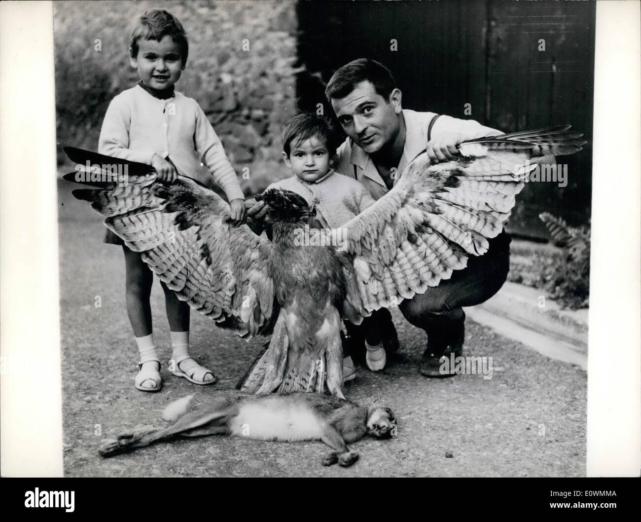 Sep. 09, 1963 - The Hunter, The Great Horned Owl and the Hare: Robert Bombail was out hunting during his holidays at Pouzolsminervois (Indre, France) when with a master shot he shot down a great horned Owl holding in its claws a hare, which weighed 69 pounds, while the horned Owl measures outstretched 1m.70. Picture Shows: Robert Bombail and his two children admire the horned owl and the hare. Stock Photo