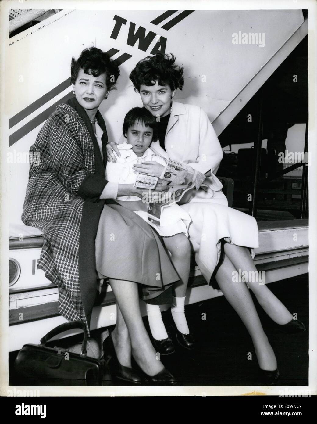 Oct. 10, 1963 - Polly Bergen,(right) who starred on TV in the Helen Morgan Stoy last Thursday night, gets the New York critics' reviews from her daughter, Kathy, 9, on her arrival  via TWA from Los Angeles. The show as telecast live from Hollywood. At left is Sylvia Sydney, who played Helen's Mother. Stock Photo