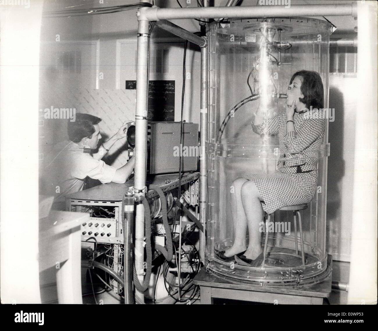 Oct. 30, 1963 - R.A.F Institute of Aviation Medicine:A visit has been held to the Royal Air Force Institute of Aviation Medicine at Farnborough. Photo shows Inside the perspex tube taking a body plethysmograph for high altitude tests is 19-year-old Maryan Baker, a scientific assistant. The device allows measurement of the resistance of air flow into and out of the lungs, of the volume of gas in the lungs, and of the flood of blood through the lungs. Stock Photo