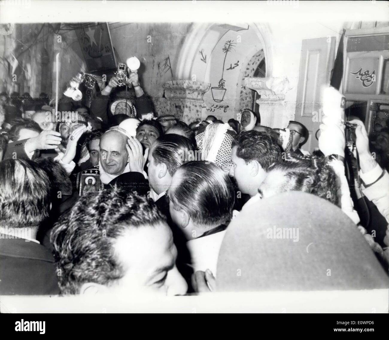 Jan. 05, 1964 - The Pope is Mobbed in the Streets of Jerusalem: Pope Paul who is on a three day pilgrimage to the Holy Land, had a great reception from the people of Jerusalem where the streets were Jammed by thousands of people and the Jordanian police and troops had to use refile buts and batons to get the pope through. photo shows Pope Paul can be seen as the crowds surge a found him in the streets of Jerusalem. Stock Photo