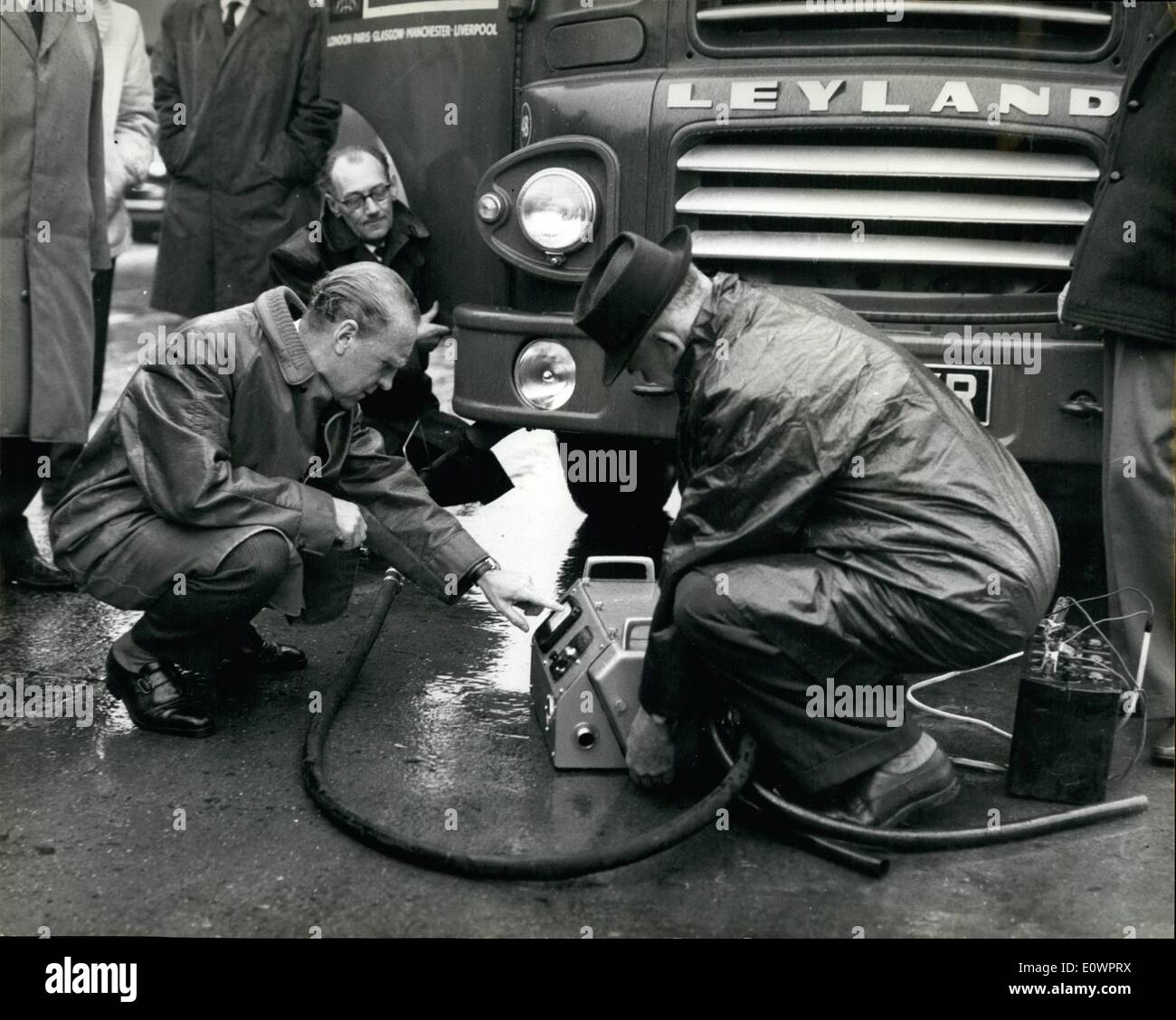 Nov. 11, 1963 - Mr. Marples checks for Diesel Fumes. The Transport Minister Mr. Ernest Marples, was present this morning at a roadside spot check on diesel engined goods vehicles emitting excessive smoke. These checks are carried out by Ministry examiners in conjunction with the police. Photo shows: Mr. Marple checks the amount of smoke pollution from a lorry by means of a special machine connected to the exhaust pipe. Stock Photo