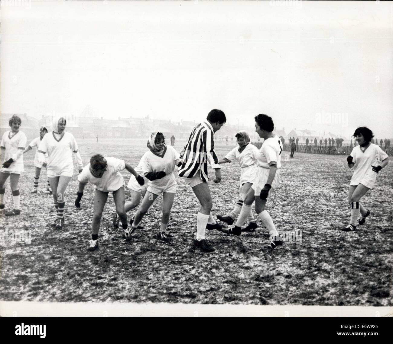 Jan. 13, 1964 - Football Match Or Twisting session? Looking more like a ''twisting session'' at the local dance hall, this incident took place during a charity match played between the Partridge Football Club and a team of their wives and sweethearts in aid of the old people at St. Paul's Cray in Kent yesterday, refereed by Charlton Athletic star Eddie Firmani. At the end nobody really knew who had won, although the girls claimed that they were the victors by 7-6. Stock Photo