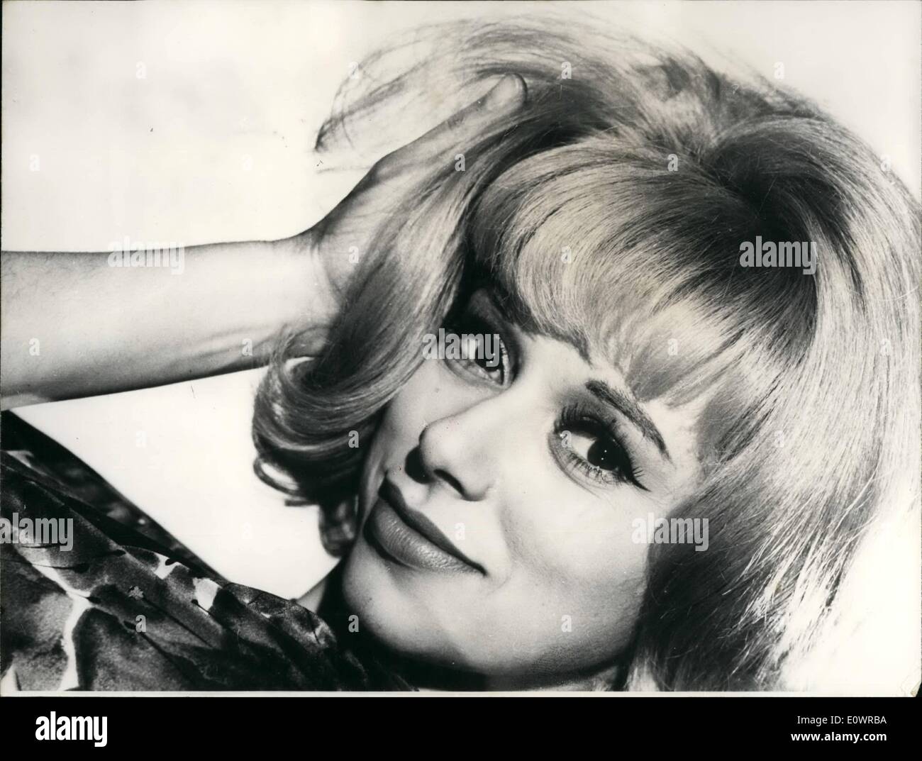 Feb. 02, 1964 - Young Actress Mireille Darc is the latest Co-star of ''Mister'' Jean Gabin; Young Actress Mireille Darc was selected to be the co-star of Jean Gabin in the latter's film ''Mister'' directed by Jean Paul Le Chanois. Her charm easily conquered the great old man of the French movies who in this film will play the part of a rich banker that twist of fate make him a servant. Photo Shows Mireille Darc as she appears opposite Jean Gabin in ''Mister' Stock Photo