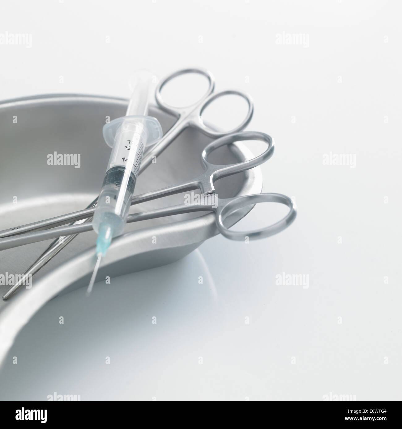 two surgical scissors and a syringe Stock Photo