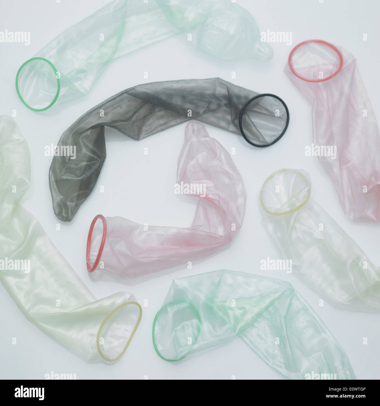 several different color used condoms on the table Stock Photo