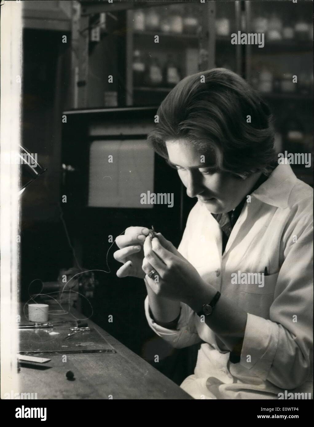 Mar. 03, 1964 - It's a million to one You'll never Guess. What is this young lady doing? Threading a needle? Sewing? Beading? . Stock Photo