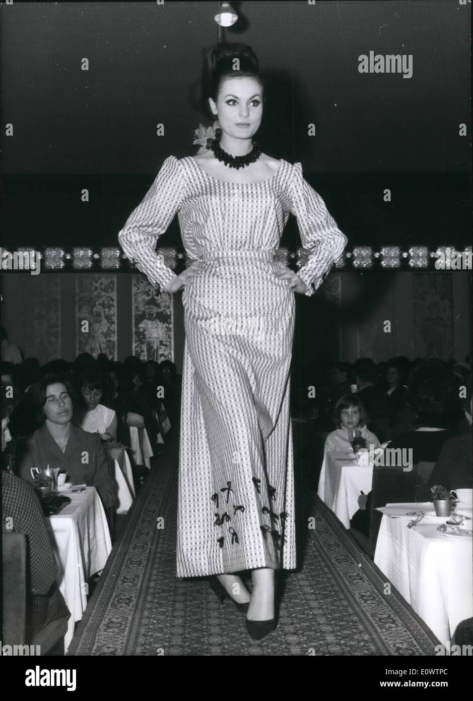Mar. 03, 1964 - Munich famous ''Dirndlkoenigin'' at Haute Couture Till Friday 6th march, Munich Dirndlkoenigin was only making ''Bavarian-Look'', - but since this time Dirndlkoenigin will create also big evening-dresses, like to see on our picture. A drindl-evening-dress, made of white-red cotton. Stock Photo