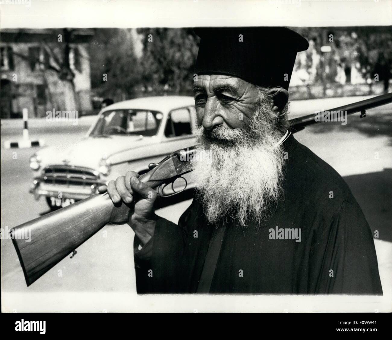 Mar. 03, 1964 - Greek Orthodox Priest - member of the ''Home Guard'' - In Nicosia: Photo shows a member of the Greek Orthodox Priesthood - complete with his rifle - seen in the streets of Nicosia. He says he is a member of the ''Home Guard'' - formed during the present tension on the island. Stock Photo